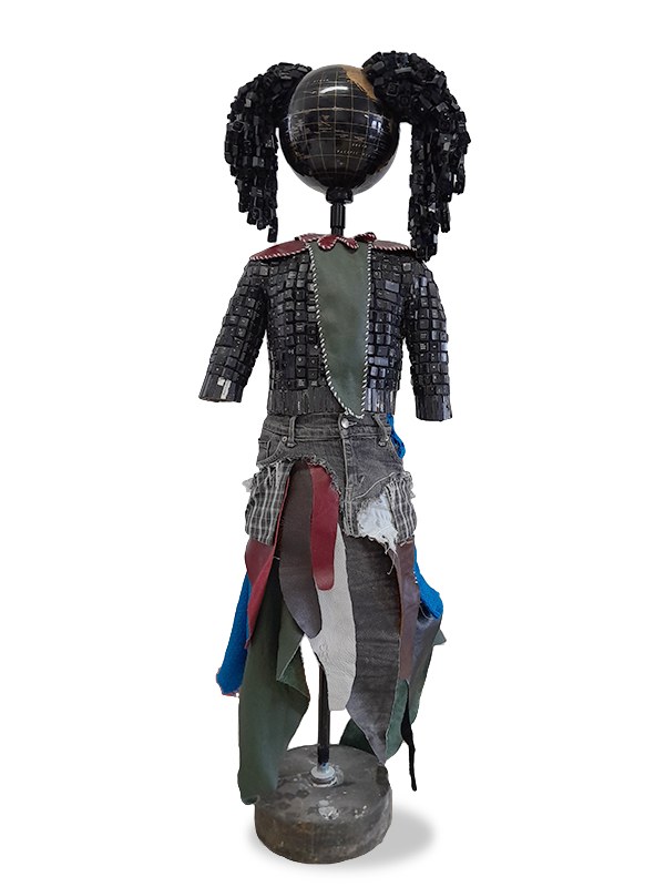 Maurice Mbikayi sculpture: Girl with a Leather Toy 1, a figure with a globe head and keyboard-key hair wearing denim and leather