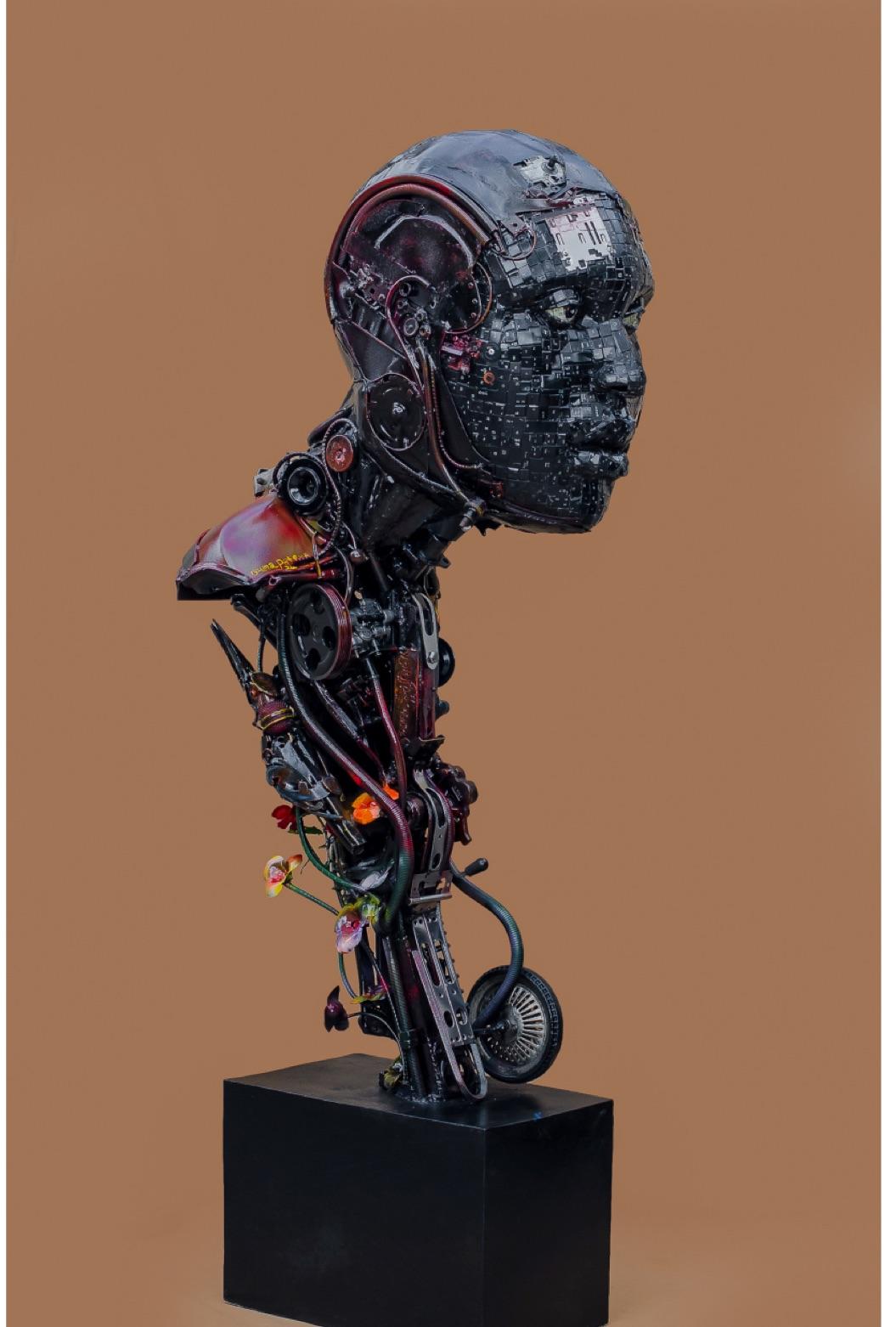 Ozuma Patrick Chidiebube work: a mechanical human head and torso assembled from recycled keyboard parts and cables, titled Mortal and Machine